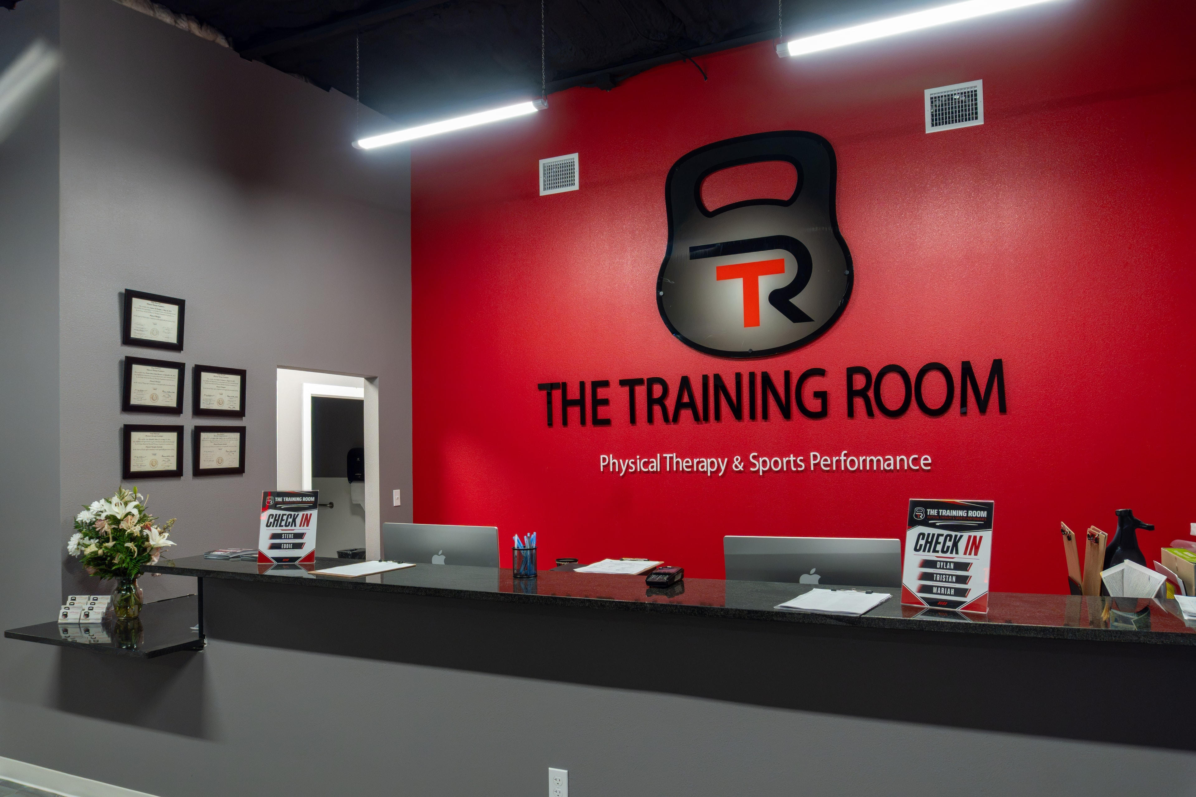 The Training Room Corpus Christi front desk and logo wall