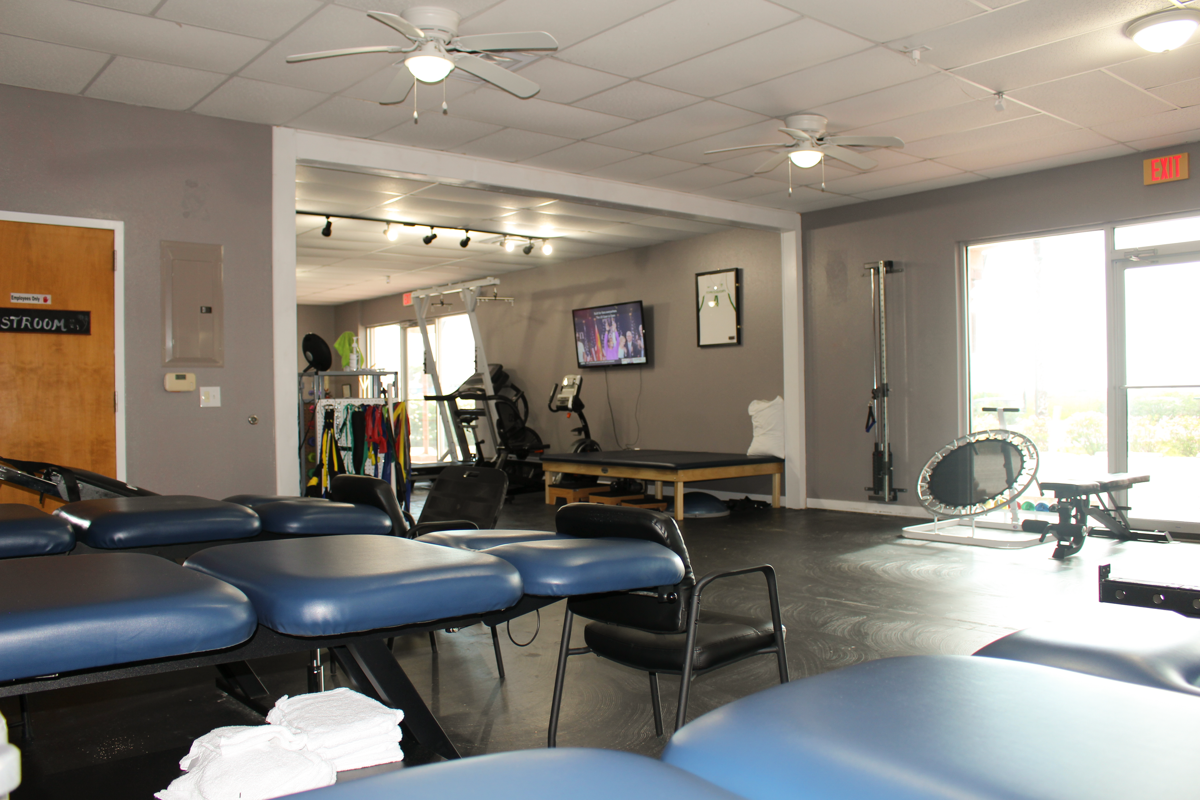 The Training Room Padre Island PT floor with treatment tables and rehab equipment