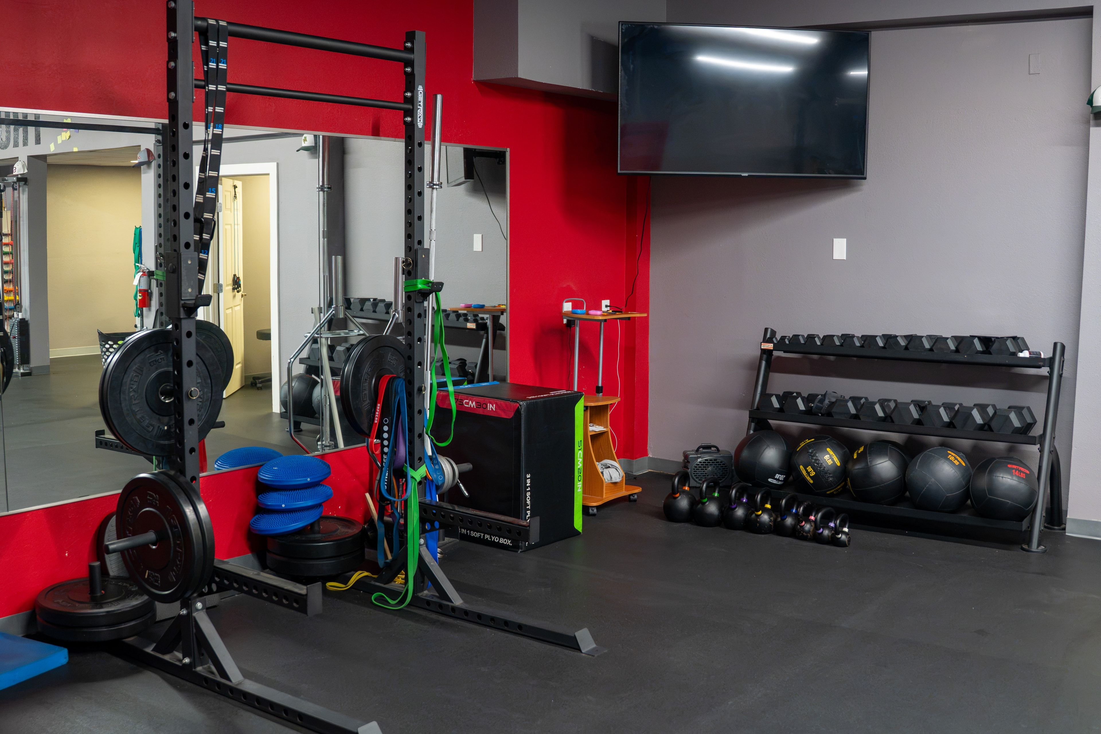 The Training Room Portland strength room with power rack, dumbbells and medicine balls