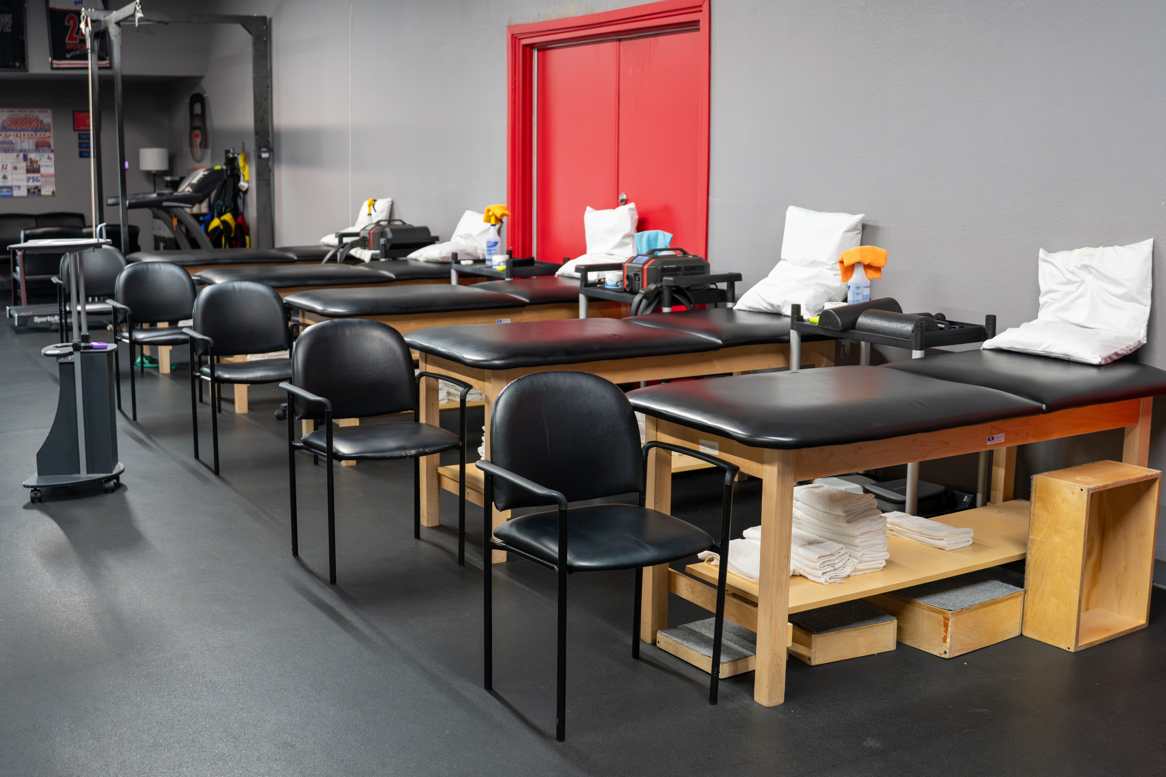 The Training Room Portland PT treatment tables with e-stim equipment and red doors