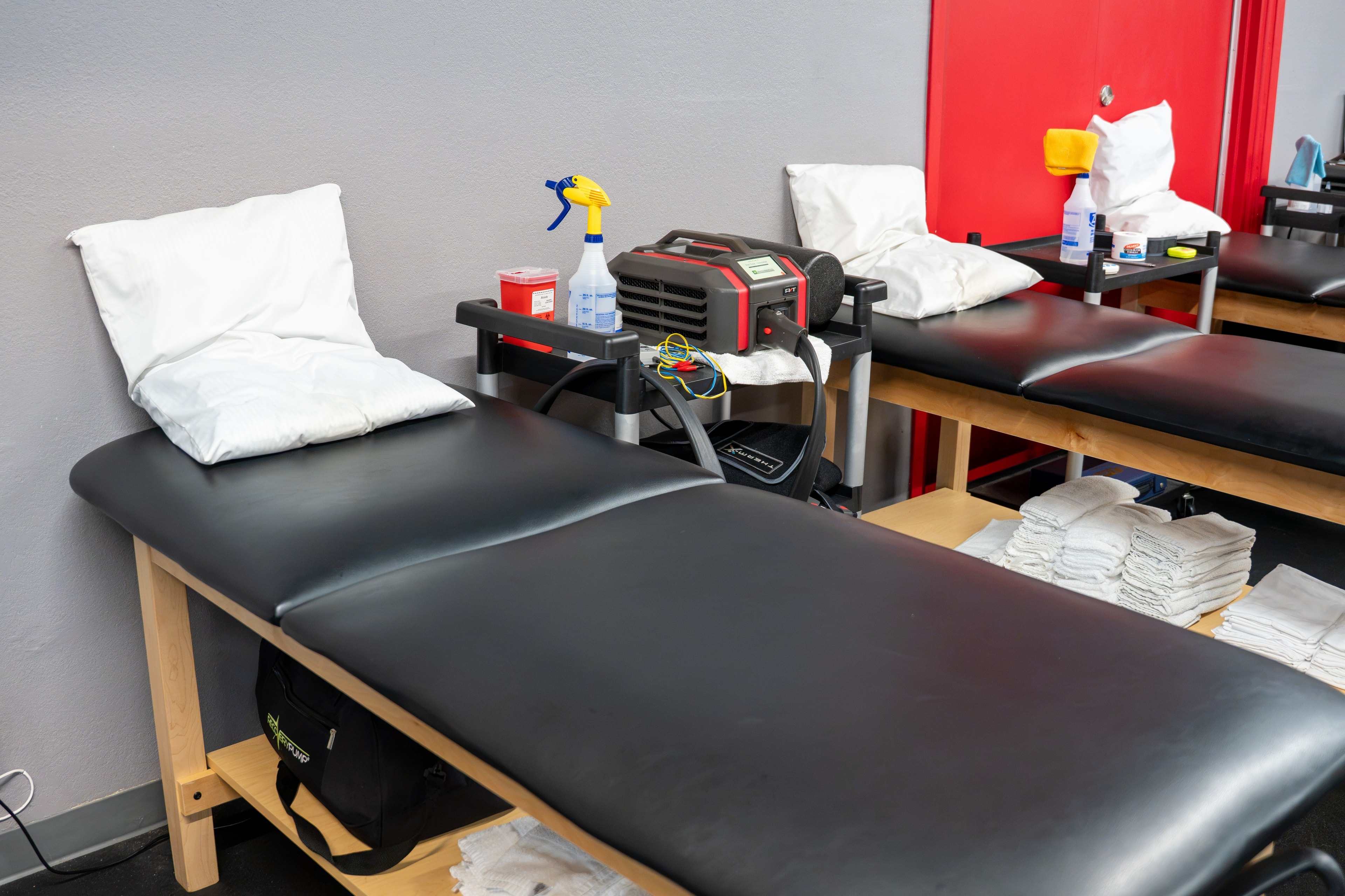 The Training Room Portland PT treatment tables close-up with e-stim equipment