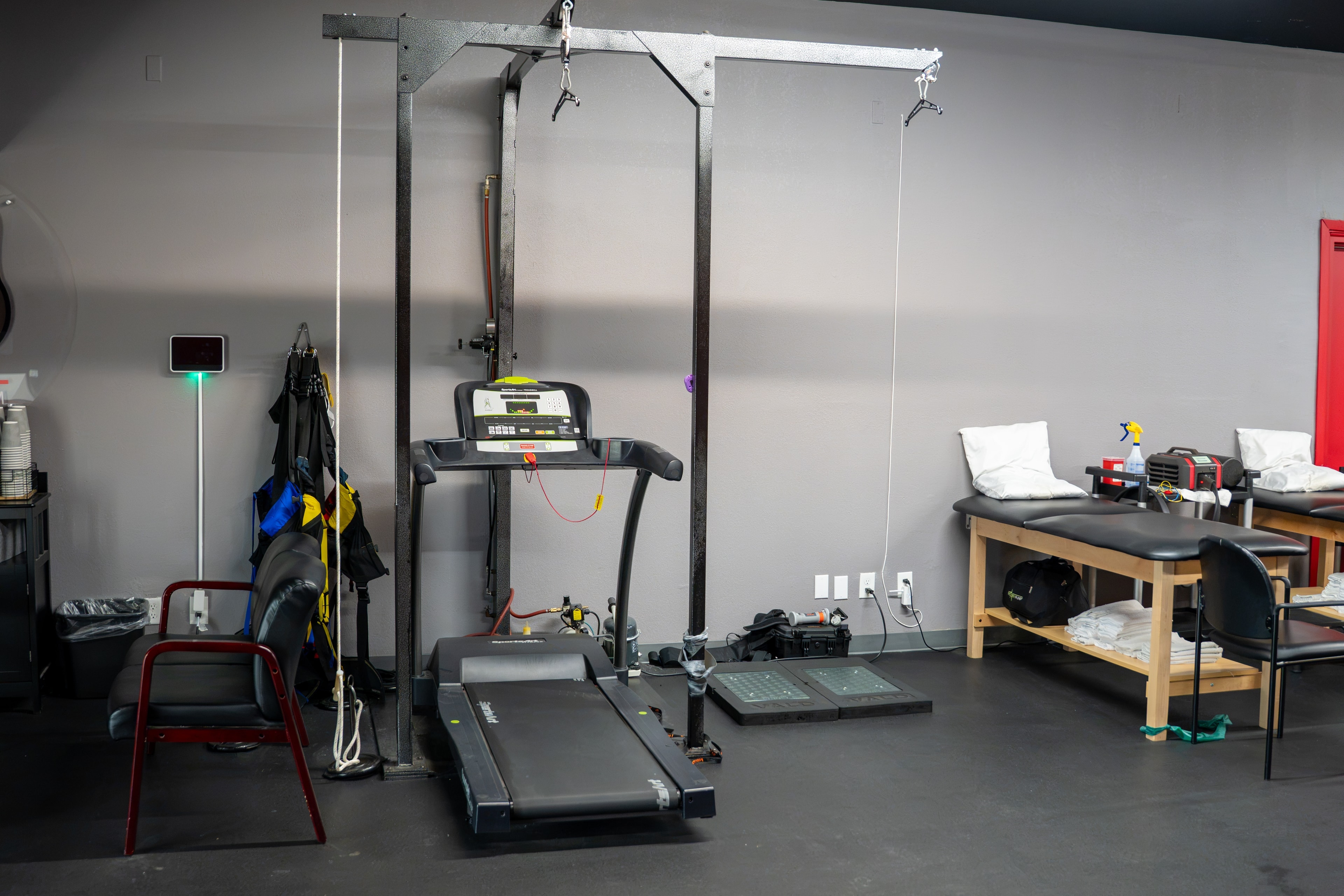 The Training Room Portland treadmill and overhead harness system with PT tables